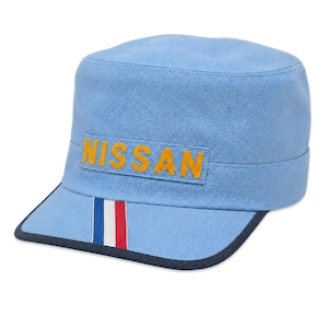 May include: A light blue cadet-style cap featuring the word NISSAN in yellow block letters on a rectangular patch. The brim includes a vertical stripe pattern in blue, white, and red, finished with a dark navy blue trim along the edge.