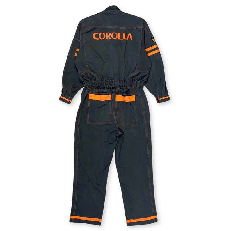 Very rare straight from Japan JDM TOYOTA トヨタ Corporate Tecno mechanic jumpsuit - coverall suite; A true gem for automotive enthusiasts seeking a unique piece of automotive history. This tsunagi is unavailable in the States, making it a rare find that sets you apart from the crowd.