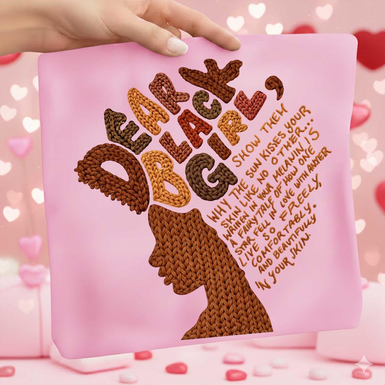 May include: A pink pillow with the words "Dear Black Girl" in a knitted font, with a silhouette of a woman's face. The text "Why the sun kisses your skin like no other..." is also on the pillow.