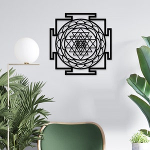 Puede incluir: Arte de pared de metal negro con un dise&ntilde;o geom&eacute;trico con un patr&oacute;n de mandala. El dise&ntilde;o es un Sri Yantra, un s&iacute;mbolo sagrado en el hinduismo.