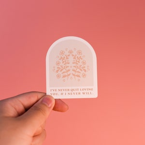 May include: A white sticker with a floral design and the text "I've never quit loving you, & I never will."