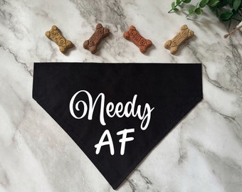 May include: Black dog bandana with white text that reads "Needy AF".