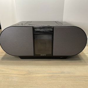 May include: A black Sony boombox with a CD player and two large speakers. The display shows "PLAY" and the time 01:49.