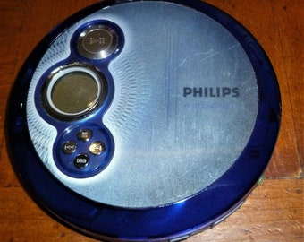 May include: A blue and silver Philips CD player with a digital display and buttons for playback control.