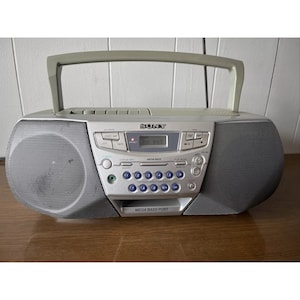 May include: A silver Sony CD, cassette, and radio boombox with a digital display that reads "Fit 947". The boombox has a large speaker on each side and a control panel with buttons for radio, CD, tape, and other functions. The boombox also has a "Mega Bass" feature and a "Mega Bass Port".