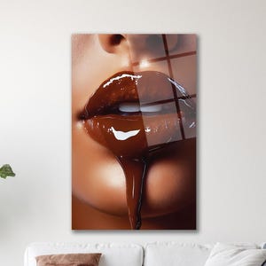 May include: Close-up of glossy, chocolate-coloured lips with a dripping effect. The image highlights the texture and shine of the lips, with a focus on the rich, dark brown colour and the dripping chocolate.