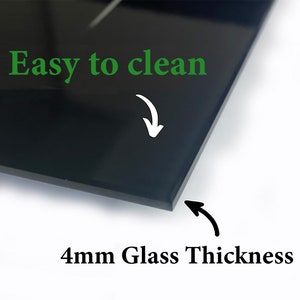 May include: A close-up of a black glass panel with the text "Easy to clean" in green and "4mm Glass Thickness" in black. White arrows point to the glass surface and edge. The glass is 4 millimeters thick.