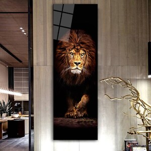 May include: A vertical art print featuring a majestic lion. The lion has a full, brown mane and is set against a dark background. The lion's face is detailed, with a focused gaze. The artwork is framed and ready to hang.