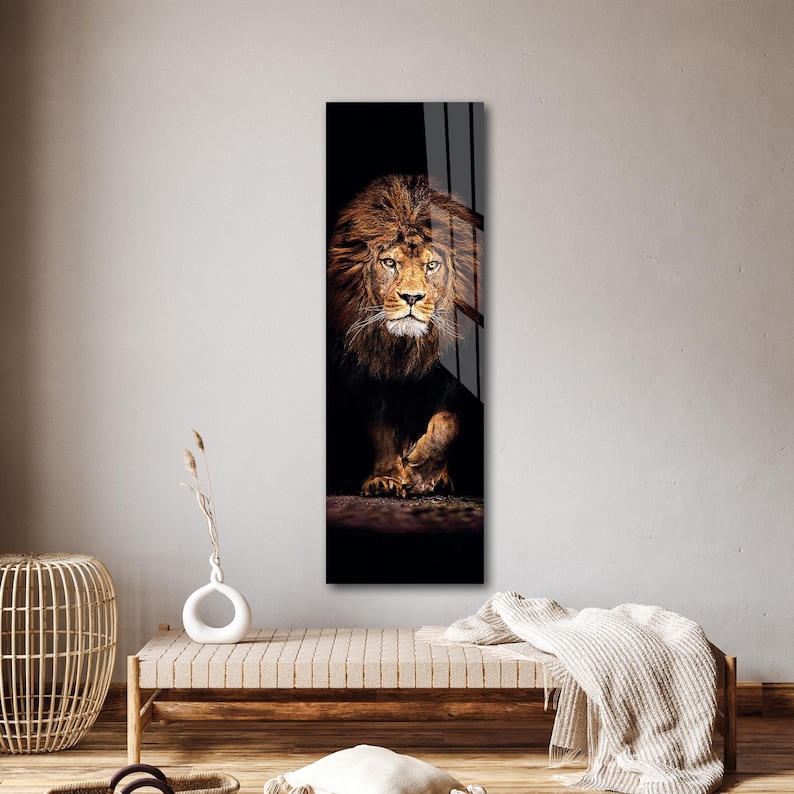 May include: A vertical art print featuring a majestic lion. The lion's golden mane and face are illuminated against a dark background. The artwork captures the lion's intense gaze and powerful presence, creating a striking visual.