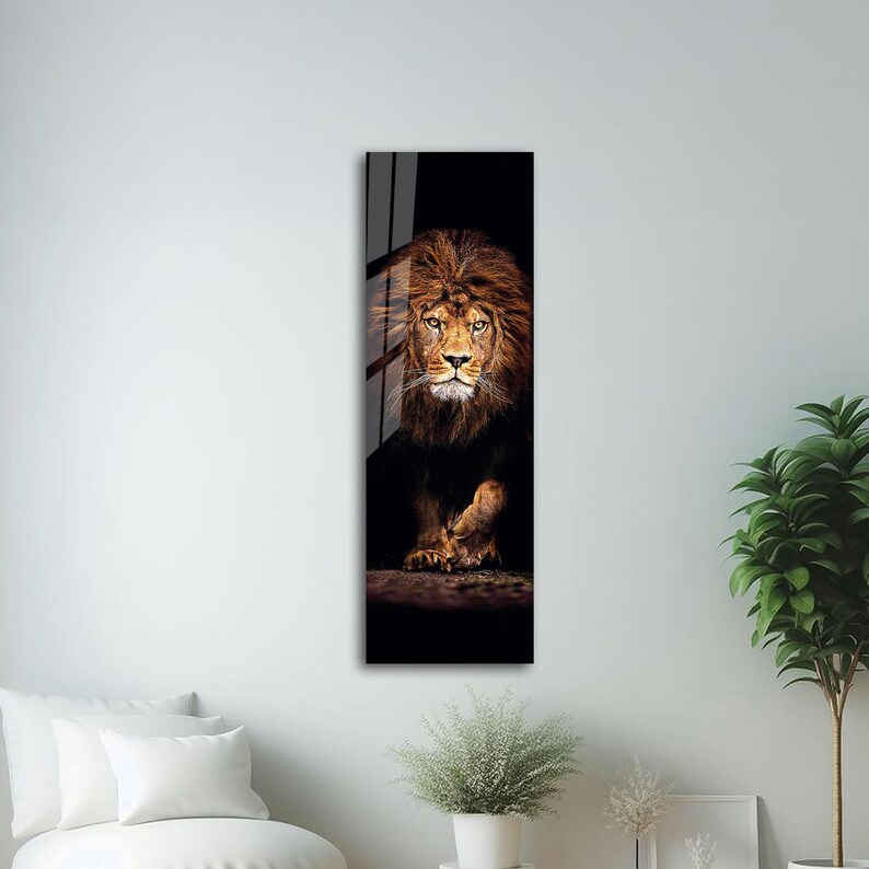 May include: A vertical rectangular wall art print featuring a majestic lion. The lion has a golden mane and is set against a dark background. The artwork is framed and ready to hang, adding a touch of wildlife to any room.
