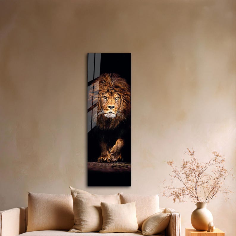May include: A vertical art print featuring a majestic lion. The lion has a full, brown mane and piercing eyes. The artwork is set against a dark background, with the lion's form emerging from the shadows.