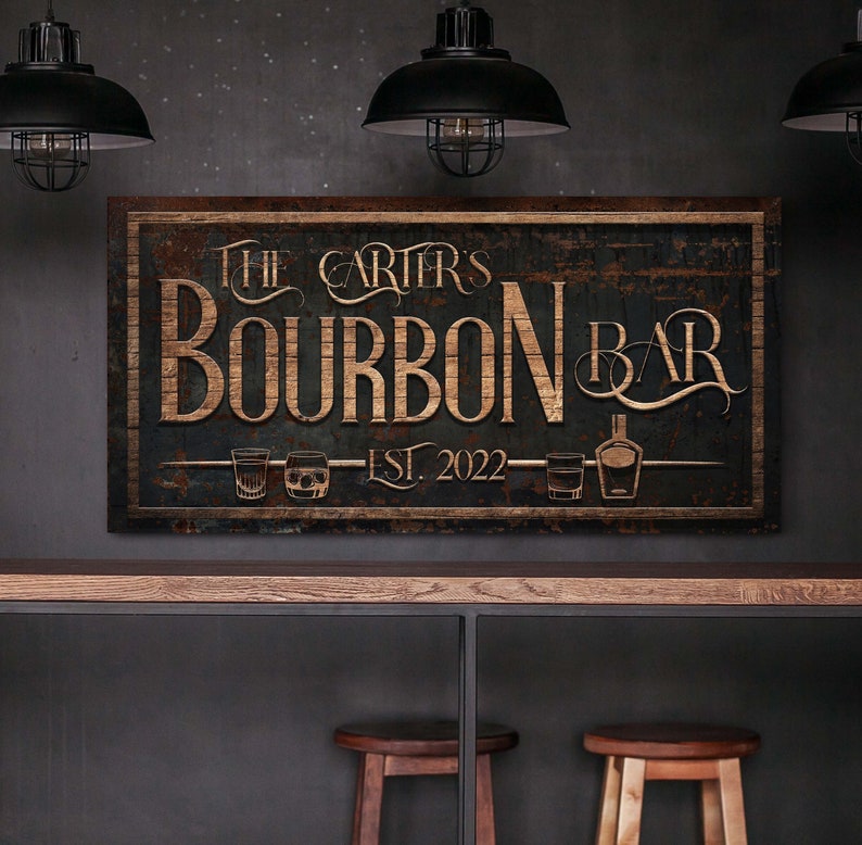 May include: Rustic wooden sign with the text "The Carter's Bourbon Bar Est. 2022" in gold lettering. The sign has a distressed, weathered look and features two glasses of bourbon and a bottle of bourbon.