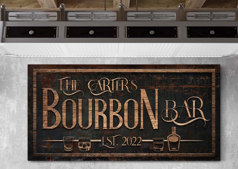 May include: A rustic wooden sign with the text "The Carter's Bourbon Bar Est. 2022" in gold lettering. The sign has a distressed, weathered look and features three glasses of bourbon and a bottle of bourbon.