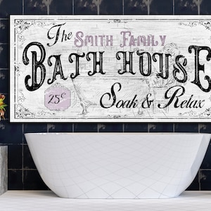 May include: A white wooden sign with black lettering that reads "The Smith Family Bath House 25&cent; Soak & Relax". The sign is hanging above a white bathtub in a bathroom with dark blue tile.