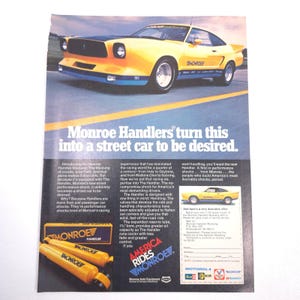 May include: An advertisement for Monroe Handler shocks, featuring a yellow Mustang. The ad includes text promoting the shocks' performance and handling capabilities. The Monroe Handler logo and product images are also displayed.