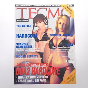 May include: A magazine cover for the video game "DOA2 Hardcore" featuring two women in bikinis. The cover has the title "Tecmo" in large red letters, with text promoting the game's features and characters.