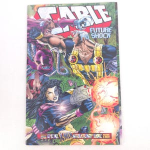 May include: A comic book cover featuring the title "CABLE" in large red letters. The cover depicts several characters in action, with the words "FUTURE SHOCK" and "X-MEN ANNIVERSARY ISSUE" visible.