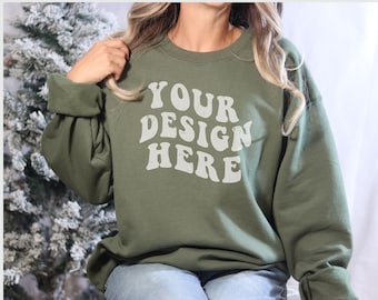 May include: A green sweatshirt with the text "YOUR DESIGN HERE" in white on the front.
