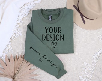 May include: A green sweatshirt with the text "YOUR DESIGN" on the front and "your design" on the sleeve. The sweatshirt has a heart design on the front and sleeve.