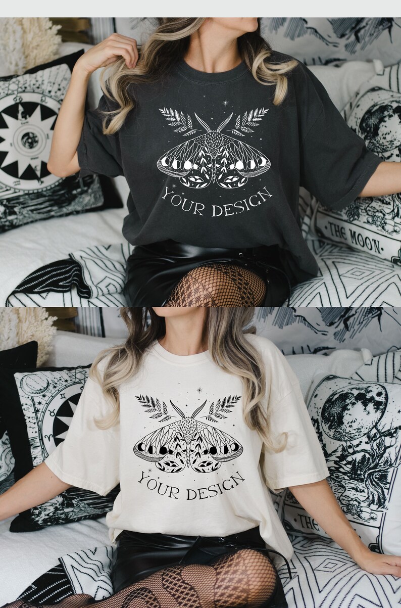 May include: A white and a charcoal gray t-shirt with a black and white graphic of a moth with moon phases and the text "YOUR DESIGN" printed on the front.