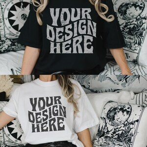 May include: Two t-shirts with the text "YOUR DESIGN HERE" in a retro, distressed font. The shirts are black and white and are shown on a model wearing black leggings.