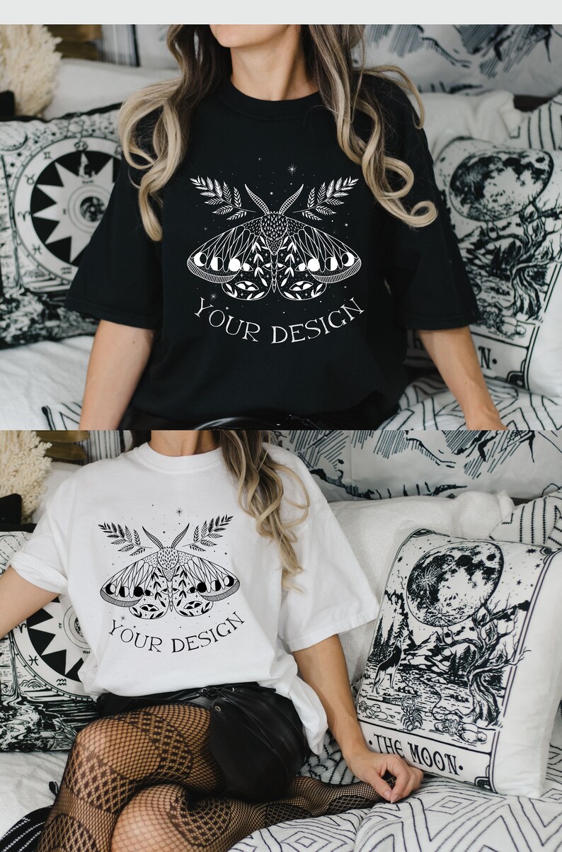 May include: Two t-shirts with a black and white graphic of a moth with wings made of crescent moons. The text "YOUR DESIGN" is printed below the moth on both shirts.