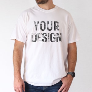 May include: A white t-shirt with a black distressed print that says "YOUR DESIGN".