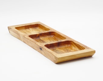 May include: A wooden serving tray with three separate compartments. The tray is made of light brown wood and has a natural finish.