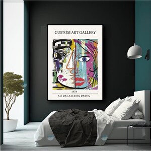 May include: A colorful abstract painting of a face with a black and white background. The painting is framed and has the text "CUSTOM ART GALLERY", "1978", and "AU PALAIS DES PAPES" printed below the image.
