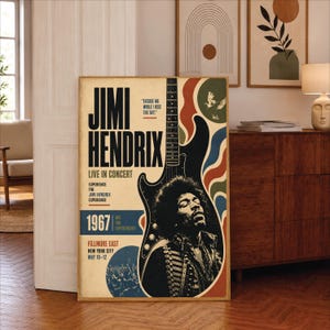 May include: A vertical concert poster featuring a black and white portrait of Jimi Hendrix, a guitar silhouette, and text including Jimi Hendrix, Live in Concert, 1967, Fillmore East, New York City, May 10-12, and Excuse me while I kiss the sky.