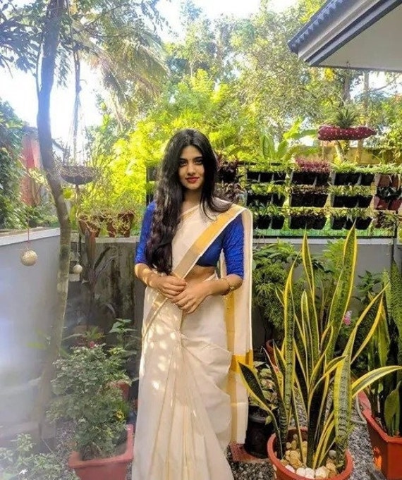 Draped in a reddish hued traditional bridal saree , embellished with kerala  traditional Ornaments and decored with white flowers is the N... | Instagram