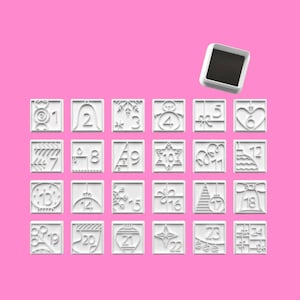 May include: A set of twenty-four white square cookie cutters, each featuring a unique holiday-themed embossed design and a number from 1 to 24. A single detached white square frame is positioned above the grid of cutters against a pink background.