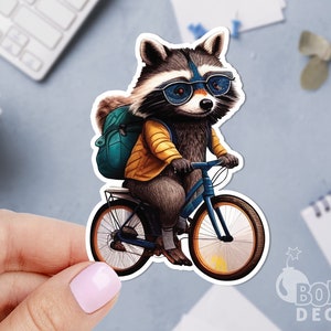 May include: A raccoon wearing blue sunglasses and a yellow jacket rides a blue bicycle with a teal backpack.