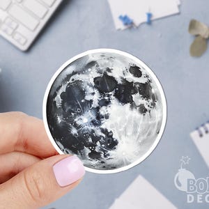 May include: A black and white moon sticker with a detailed illustration of the moon's surface.