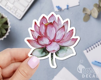 May include: A pink watercolor lotus flower sticker with green leaves. The sticker is on a white background.