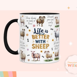 May include: White ceramic mug with a black handle. The mug features a colorful design of sheep and flowers with the text "Life is Better With Sheep".