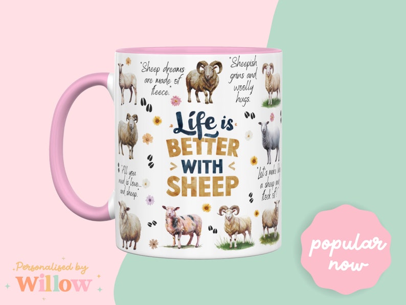 May include: White ceramic mug with a pink handle. The mug features a design of sheep and the text "Life is Better With Sheep".