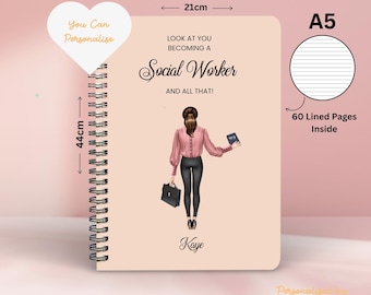 May include: A pink A5 notebook with a spiral binding. The cover features a cartoon illustration of a woman in a pink blouse and black pants holding a briefcase and a book. The text on the cover reads "Look at you becoming a Social Worker and all that!" and "Kaye". The notebook has 60 lined pages and measures 21 cm by 44 cm.