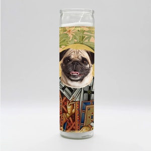 May include: A white candle with a colourful image of a pug dog dressed as a saint. The image includes a gold halo, a cross, and a book. The candle is in a clear glass jar.