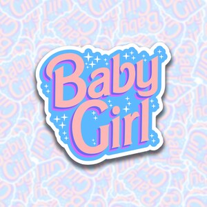 May include: A sticker with a blue background and pink lettering that says "Baby Girl" with white stars around the text.
