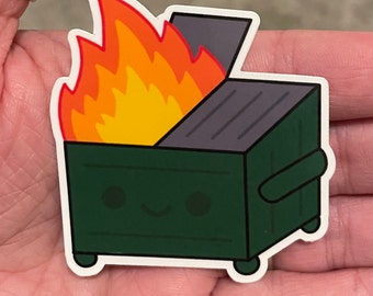 May include: A sticker featuring a cartoon dumpster on fire. The dumpster is dark green with a smiling face, and the flames are orange and yellow. The lid is open, and the sticker has a white border.
