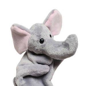 May include: Gray plush elephant hand puppet with pink ears and black trim around the wrist.