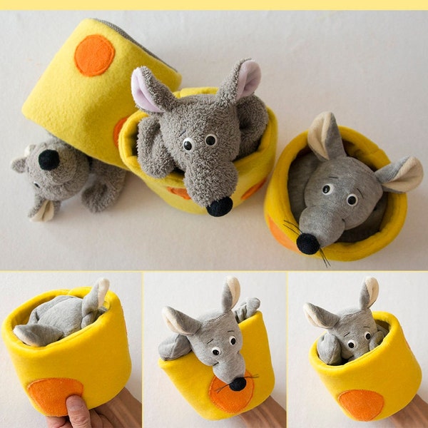 May include: Handmade gray mouse hand puppets peeking out of yellow cheese-shaped containers with orange accents. The image includes the text "eBook Handpuppe MAUS". These soft toys are perfect for children's play or educational purposes.