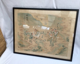 May include: Framed Asian artwork featuring a detailed illustration of figures in traditional attire amidst a landscape. The artwork is in muted tones of green, beige, and brown, with a black frame. The image includes Asian characters.
