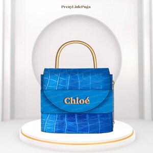May include: A blue leather handbag with a gold top handle and a gold chain strap. The bag has a flap with the word "Chlo&eacute;" embossed in gold.