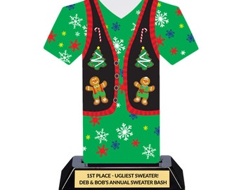 May include: A green and black Christmas sweater trophy with a gingerbread man design. The trophy has a black base with a gold plaque that reads "1st Place - Ugliest Sweater! Deb & Bob's Annual Sweater Bash".