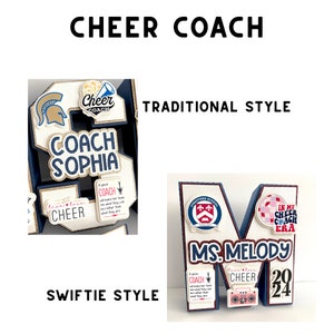 May include: Two different styles of cheer coach gifts, both featuring a large letter, decorations, and the words "Cheer Coach". The first gift is a blue and gold letter "S" with the words "Coach Sophia" and "Live Love Cheer". The second gift is a blue letter "M" with the words "Ms. Melody" and "In My Cheer Coach Era".