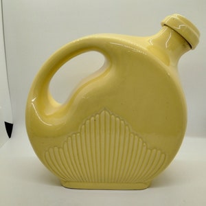 Vintage yellow water pitcher with plug