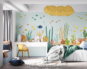 May include: A child's bedroom with an ocean-themed mural featuring colorful fish, coral, and seaweed. A white desk with a yellow chair sits in front of the mural. A bed with a white duvet and green blanket is in the foreground. A large, gold-colored cloud-shaped light fixture hangs from the ceiling.