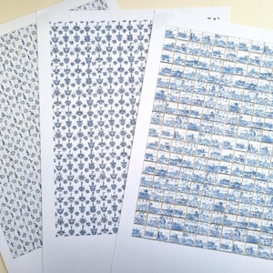 May include: Three rectangular sheets of paper featuring blue and white printed patterns. The left sheet displays a grid of small figures, the centre sheet shows a repeating floral motif, and the right sheet contains a grid of landscape scenes.